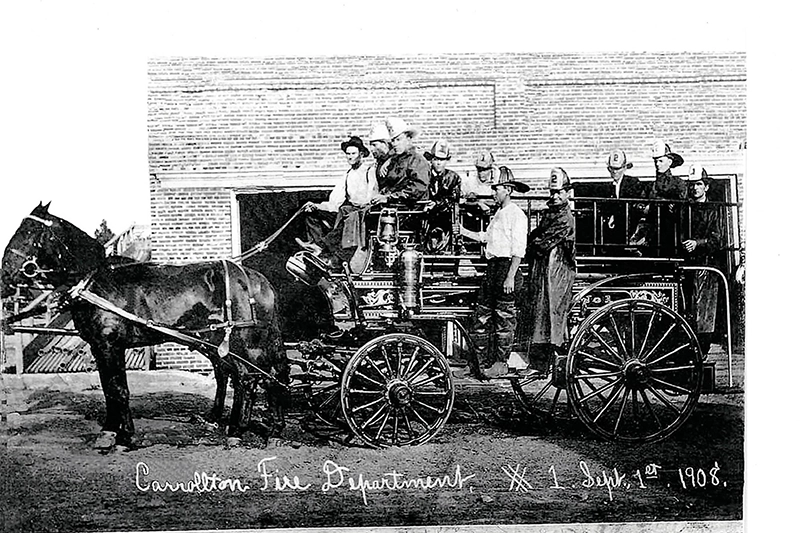 vintage photo of early fire firghters in carrollton on a horse and carriage with the text: "Carrollton Fire Department X 1 Sept 1st 1908" written in the bottom right-hand side.